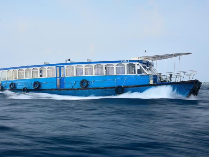 Blue local ferry underway between Malé and Thoddoo
